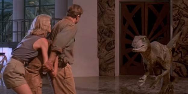 A production still showing Grant, Ellie, and the kids being triangulated by velociraptors in the visitors’ center atrium