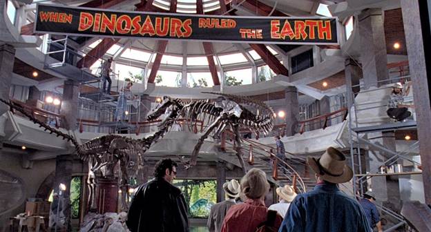 A production still from Jurassic Park (1993), showing the cast entering the atrium