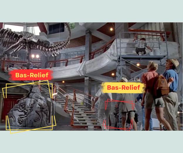 A production still from Jurassic Park (1993), showing a different angle in the atrium that emphasizes the T-Rex’s plinth; the concrete stairs and mezzanine, which are both accompanied by red, steel balusters. The image has annotations identifying the bas-reliefs on the plinth and columns that support the mezzanine