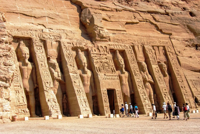 The entrance to the temple is a small door, flanked by high relief statutes of the pharoah and various gods and buttresses carved with hieroglyphics. image is from Britannica